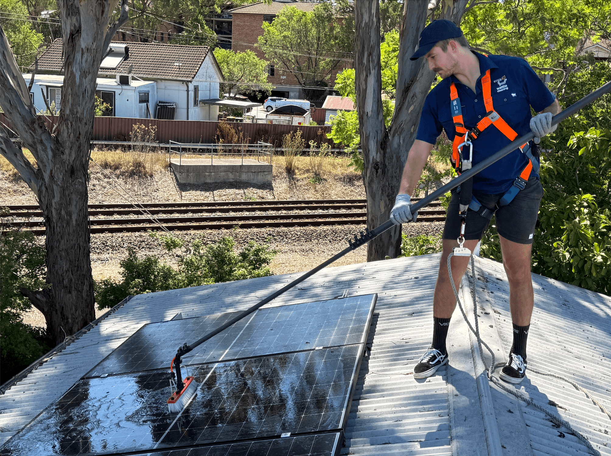 A professional cleans solar panels.