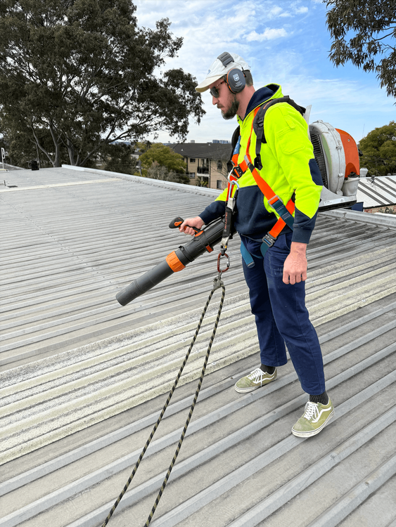 A gutter cleaner on an industrial shed roof.