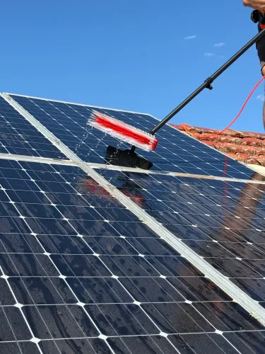 A soft, non-abrasive brush is used to clean solar panels without scratching or damaging the panel